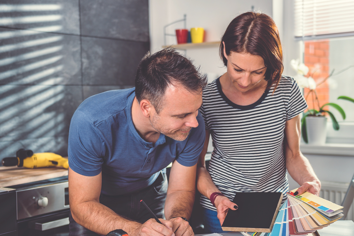 couple-looking-at-color-swatch-during-kitchen-renovation A homeowner with equity in your property? You may not need to tap into your savings to fund your renovations.
