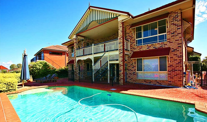 two-storey-house-bricked-walls-backyard-swimming-pool