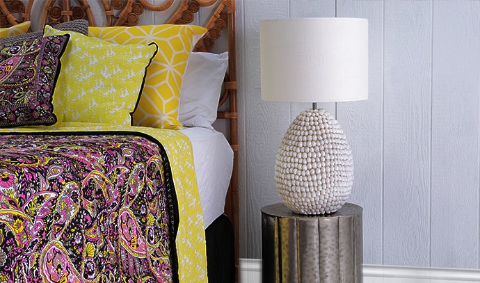 zohi-interiors-bedroom-yellow-purple-covers-white-bedside-lamp