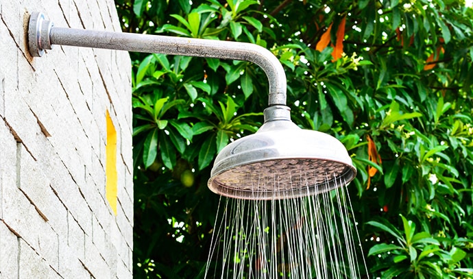 outdoor-shower-head-nearby-trees