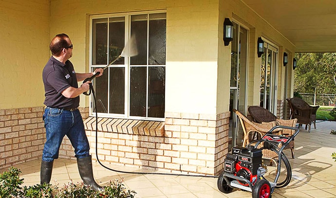 pressure-washer-man-cleaning-windows-outdoor-home