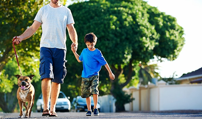 man-walking-his-dog-with-his-son