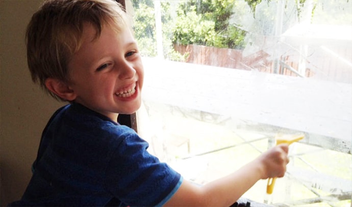 little-boy-having-fun-cleaning-windows