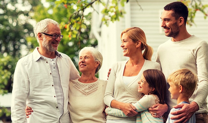 happy-family-in-front-of-home-grandparents-mum-dad-grandparents-kids