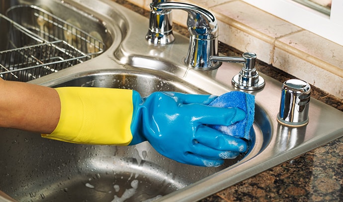 cleaning-inside-kitchen-sink-soapy-water-sponge