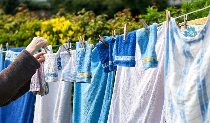 old-woman-hanging-laundry-outdoor