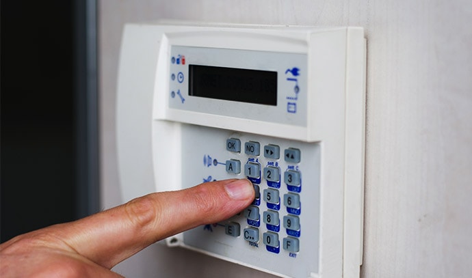 finger-pressing-keys-alarm-keypad