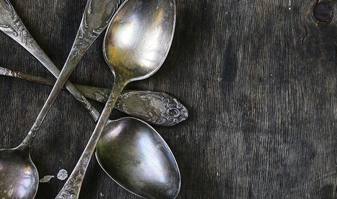 vintage-silver-spoons-on-wooden-background