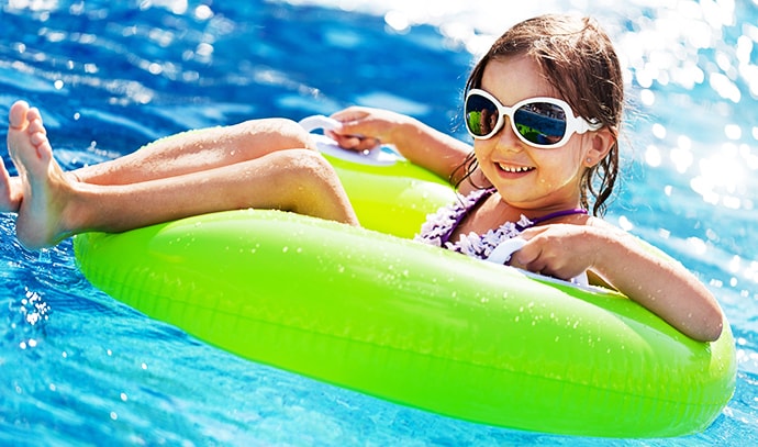 girl-enjoying-summer-swimming-wearing-sunglasses-floater-pool