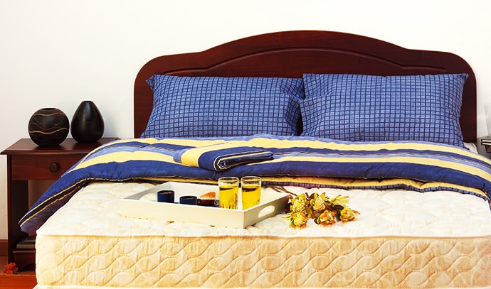blue-bed-mattress-sheets-pillows-flower-ornaments