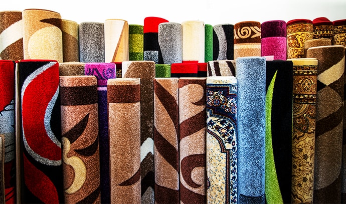 colorful-collection-carpets-rugs-folded-displayed-textured-carpet-surface-detail