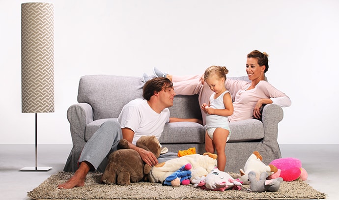 happy-family-playing-living-room-couch-carpet-floor