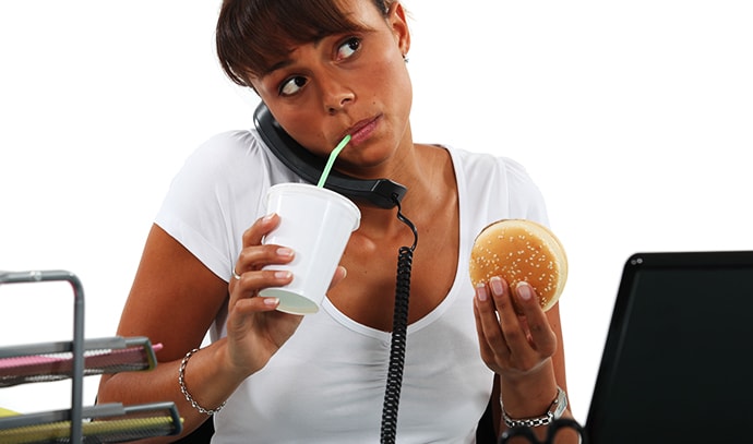 young-woman-eating-hamburger-drinking-straw-making-call