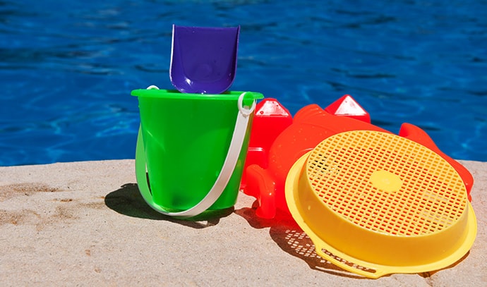 bright-colorful-children-toys-poolside-family-vacation-concept