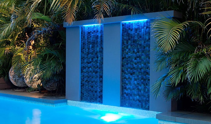 award-pools-blue-night-lit-swimming-pool-wall-falls