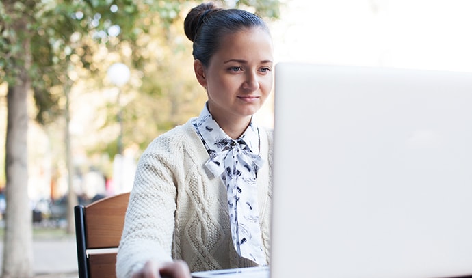 woman-using-notebook-during-work-outdoor