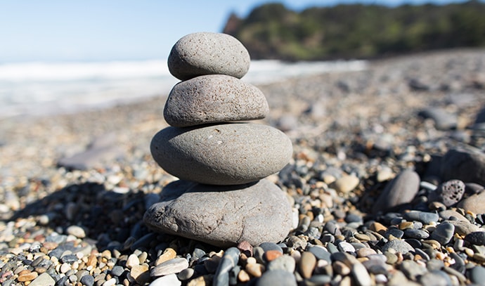 workwell-group-pebble-stones-rock-stack-beach