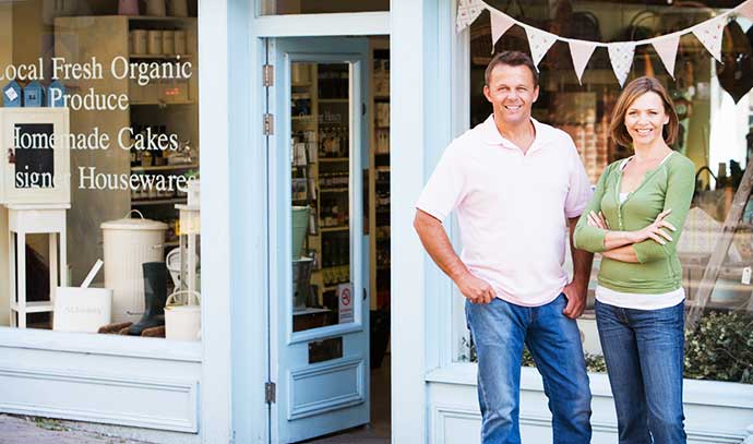 couple-standing-front-organic-food-store-smiling
