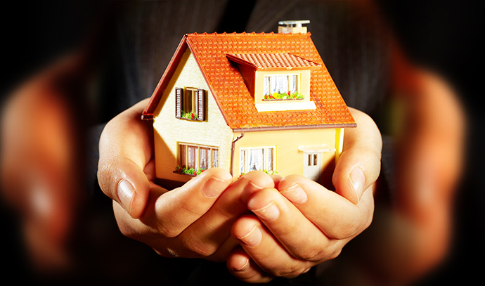hand-businessman-miniature-house-model