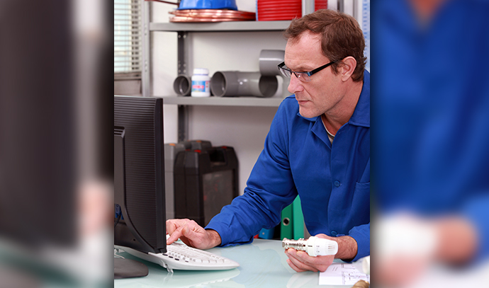 plumber-radiator-valve-blue-uniform-computer