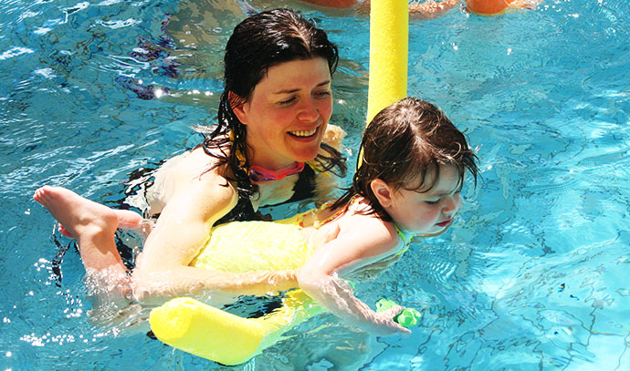 royal-life-saving-society-mother-guiding-daughter-swimming-pool-floater