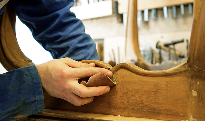 furniture-maker-polishing-wood-sandpaper-edges
