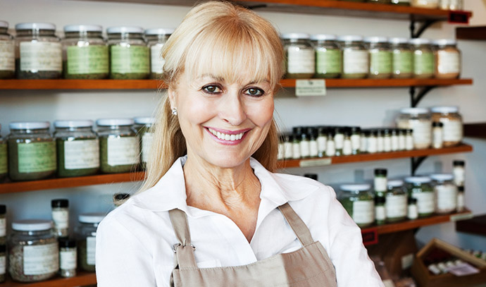 portrait-happy-senior-female-employee-spice-store