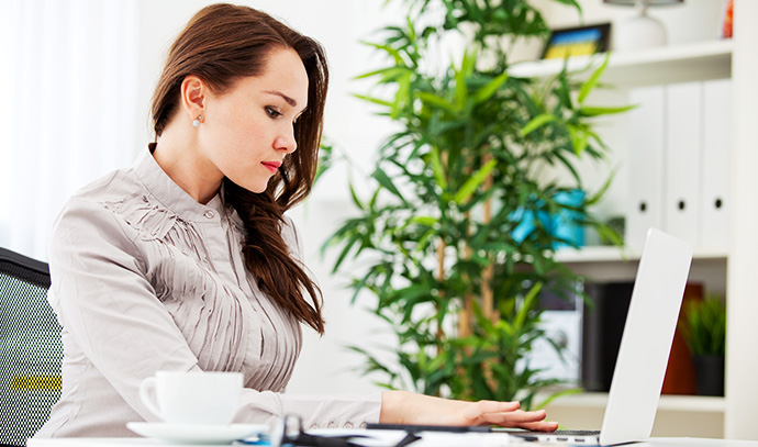woman-sitting-office-using-laptop-business