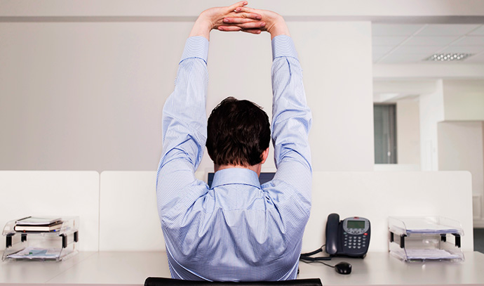 man-stretching-desk-office-businessman