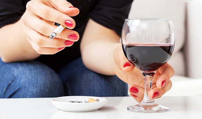 woman-smoking-cigarette-ash-tray-drinking-wine
