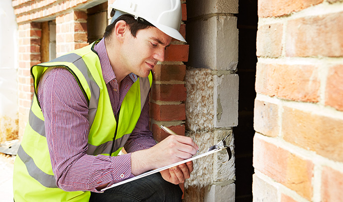 architect-wearing-hard-hat-checking-inspecting-insulation-house-construction