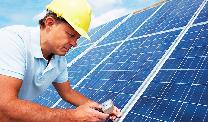 man-hard-hat-installing-solar-panel-roof