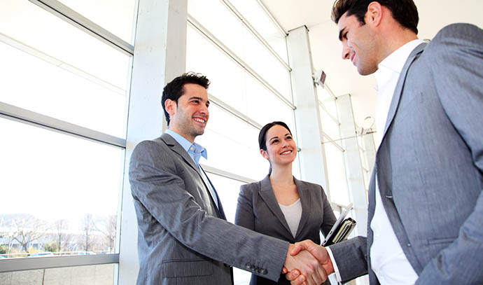 business-partners-shaking-hands-meeting-hall