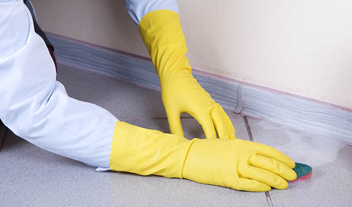 hands-yellow-gloves-sponge-washing-floor-plinth