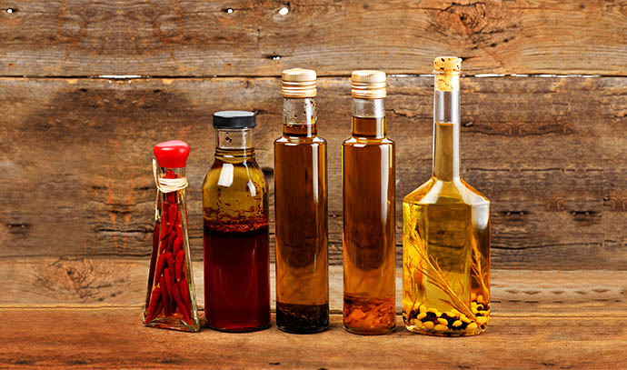 cooking-oil-assortment-bottles-wooden-background