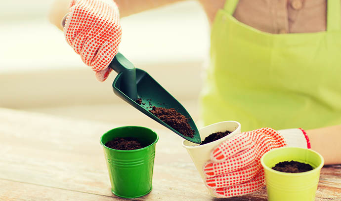 people-gardening-seeding-profession-concept-close-up-woman-hands-trowel-burying-seeds-soil