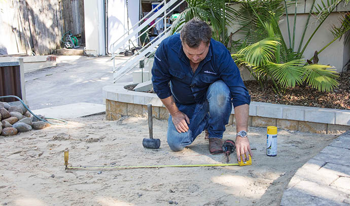 adbrimasonry-man-excavation-measuring-hammer-exterior-fire-pit