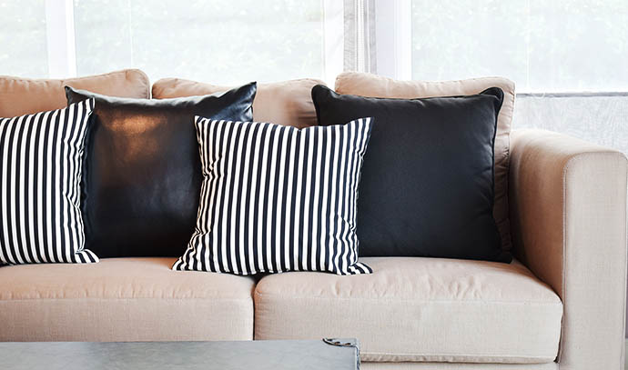 striped-black-leather-pillows-velvet-beige-sofa-modern-industrial-style-living-room