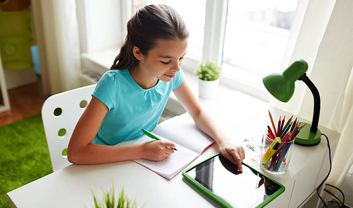 people-children-education-learning-concept-happy-girl-tablet-pc-computer-writing-notebook-home