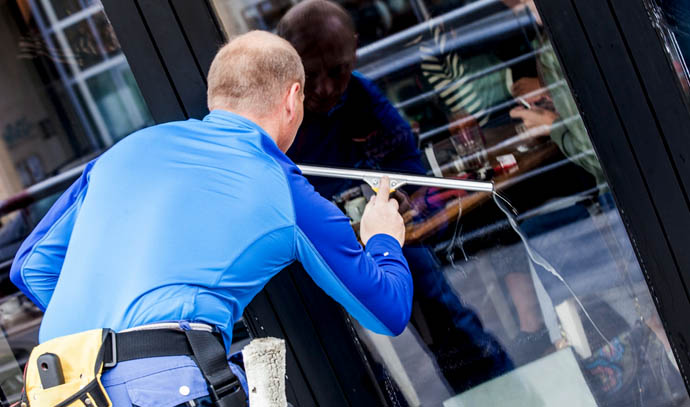 man-cleaning-window-glass-maintenance-wiper-reflection